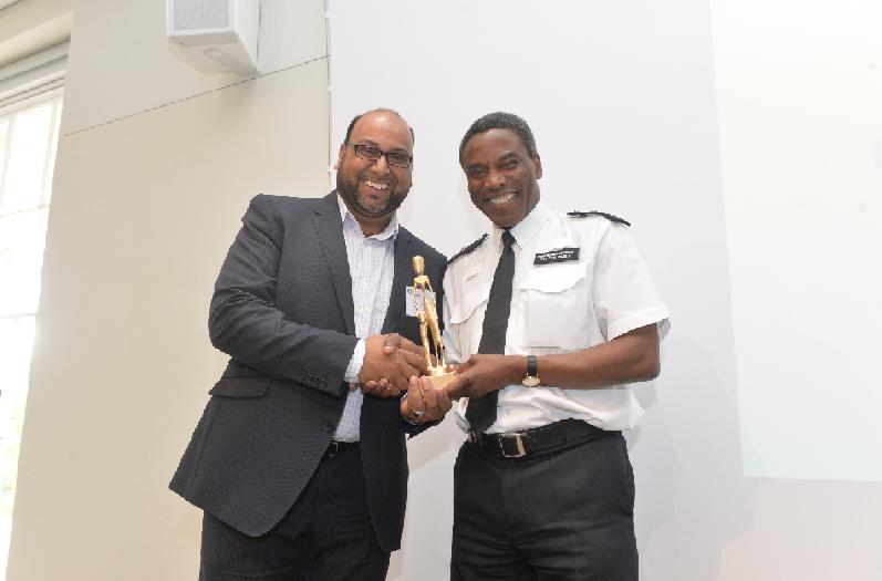 Receiving award from Chief Superintendent Victor Olisa Abdullah Molvi (Abby)Employer Compliance Manager
